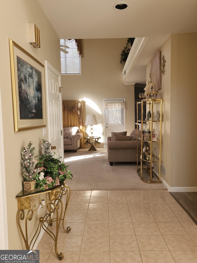 hall featuring light tile patterned floors