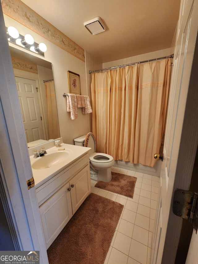 full bathroom featuring tile patterned floors, vanity, shower / bath combination with curtain, and toilet