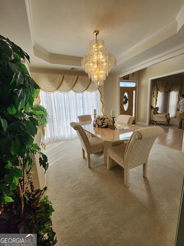 dining area with carpet, a notable chandelier, and ornamental molding