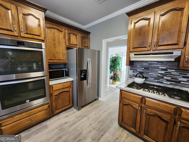 kitchen with decorative backsplash, light hardwood / wood-style flooring, stainless steel appliances, and ornamental molding