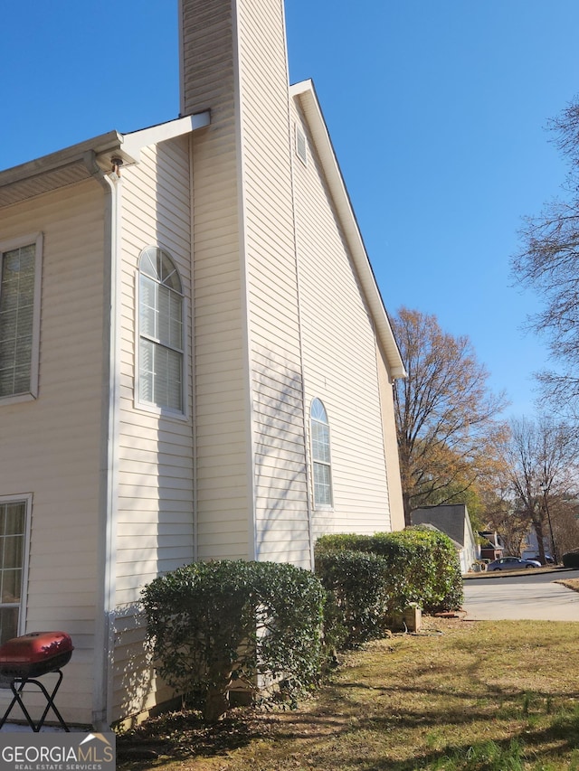 view of side of property with a lawn