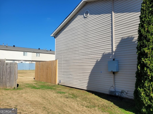 view of property exterior featuring a lawn