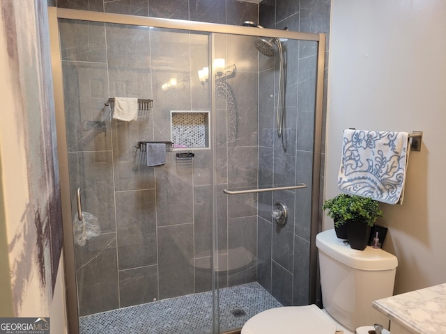 bathroom featuring walk in shower and toilet