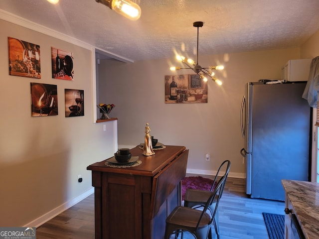 office space with dark hardwood / wood-style flooring, a textured ceiling, and an inviting chandelier