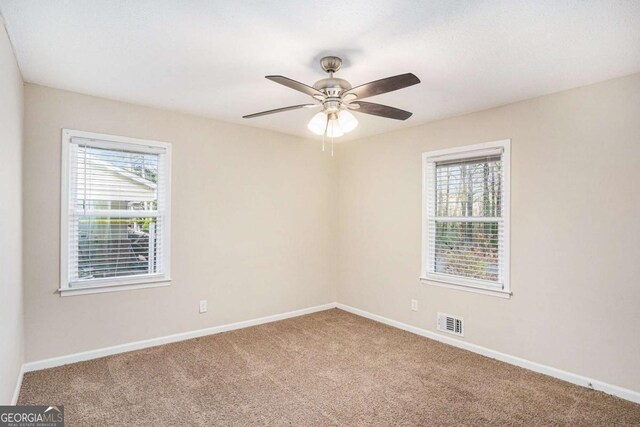 spare room with carpet flooring and ceiling fan