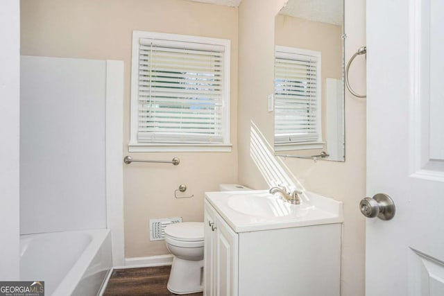 bathroom featuring hardwood / wood-style floors, vanity, and toilet