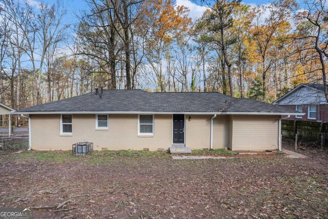 rear view of property featuring central AC