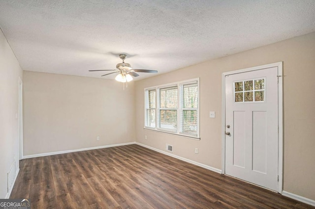 entrance foyer featuring dark hardwood / wood-style floors and a textured ceiling