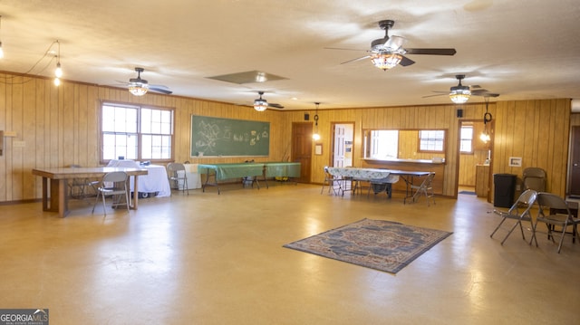 interior space with concrete flooring and wood walls