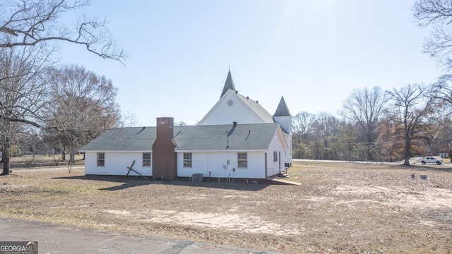 rear view of house with central AC unit