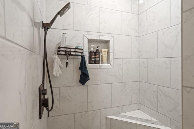 bathroom with a tile shower