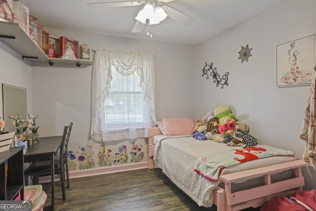 bedroom with dark hardwood / wood-style flooring and ceiling fan