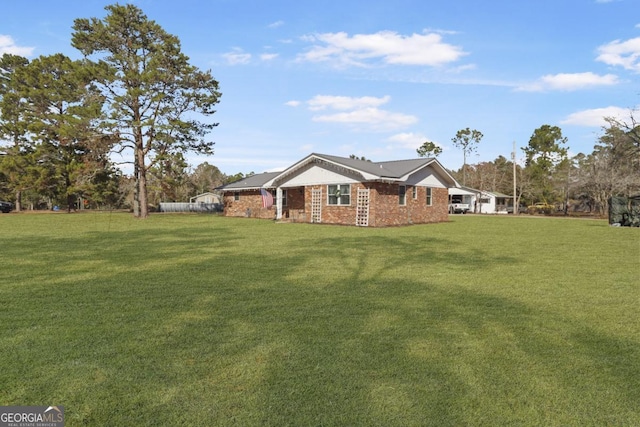 exterior space featuring a front yard and brick siding