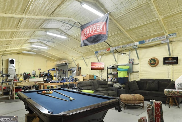 playroom with a workshop area, concrete floors, vaulted ceiling, and pool table