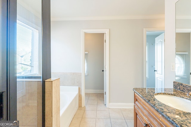 bathroom with tile patterned flooring, vanity, crown molding, and a bath