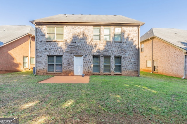 rear view of house featuring a yard and a patio area