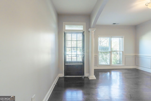 entryway featuring ornamental molding, dark hardwood / wood-style floors, and decorative columns