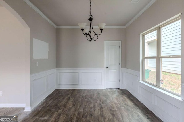 unfurnished dining area with dark hardwood / wood-style flooring, a notable chandelier, and ornamental molding