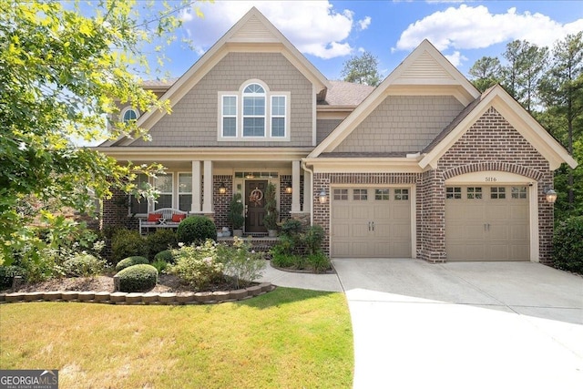 craftsman-style house featuring a front lawn and a garage