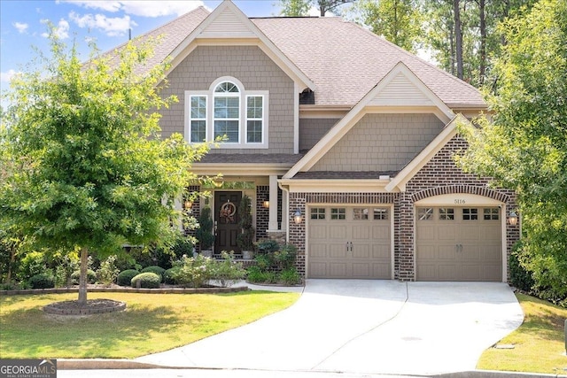 craftsman-style home with a front lawn and a garage