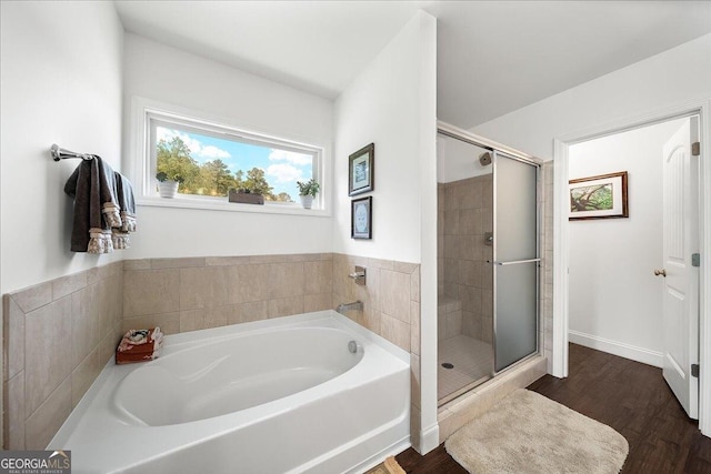 bathroom featuring hardwood / wood-style flooring and independent shower and bath