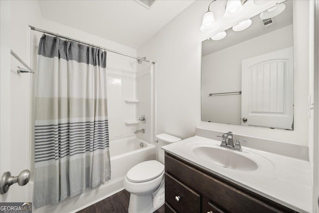 full bathroom with hardwood / wood-style floors, vanity, shower / bath combination with curtain, and toilet