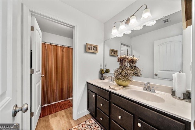 bathroom featuring hardwood / wood-style flooring and vanity