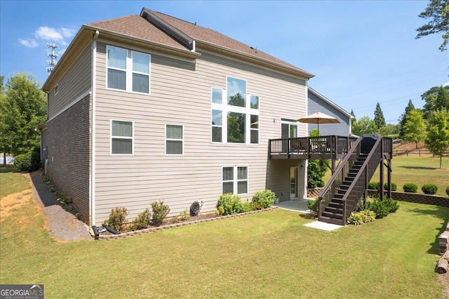 back of property featuring a lawn and a deck