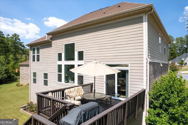 back of house featuring a deck and a yard