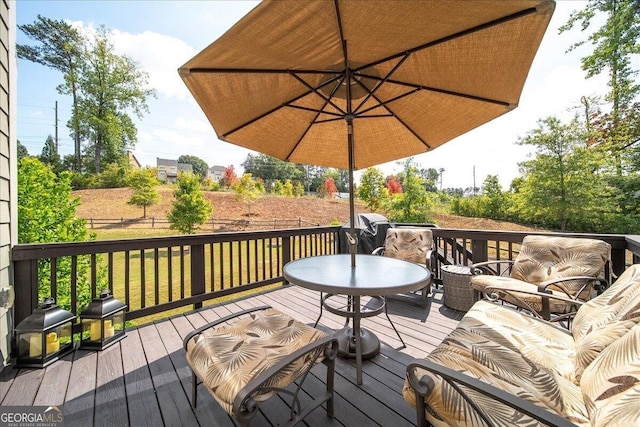 wooden terrace featuring a lawn