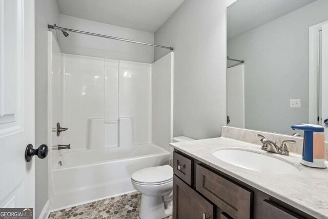 full bathroom featuring vanity,  shower combination, and toilet