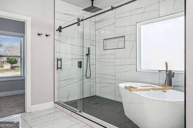bathroom featuring independent shower and bath