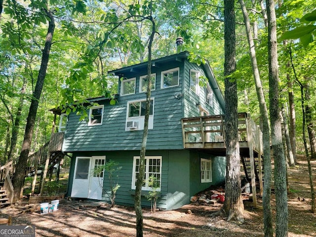 back of property featuring a wooden deck