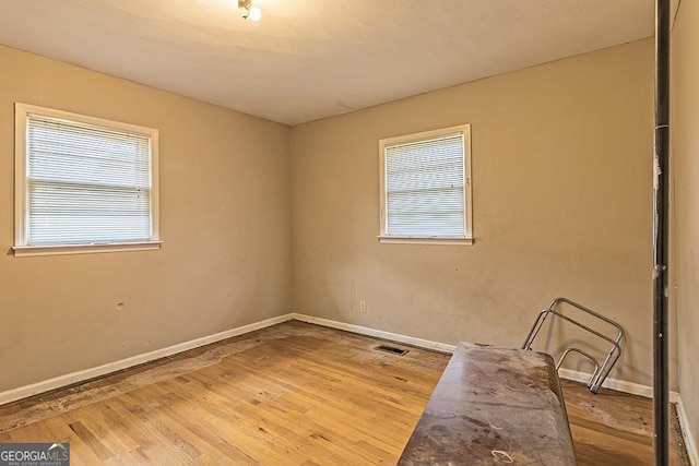 empty room with hardwood / wood-style floors