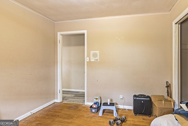 interior space featuring crown molding and wood-type flooring