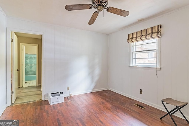 spare room with ceiling fan and dark hardwood / wood-style floors