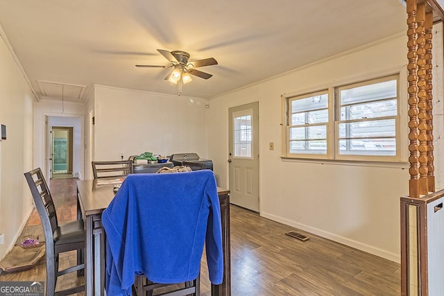 dining room with dark hardwood / wood-style floors, ceiling fan, and crown molding