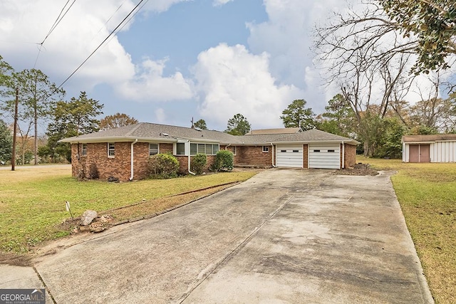 ranch-style home featuring a storage unit, a garage, and a front lawn