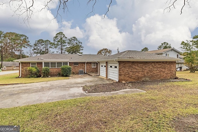 single story home featuring a front yard, central AC, and a garage