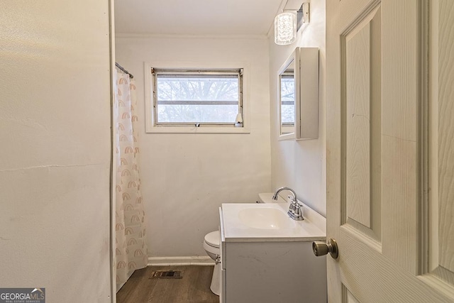 bathroom with curtained shower, toilet, vanity, and hardwood / wood-style flooring