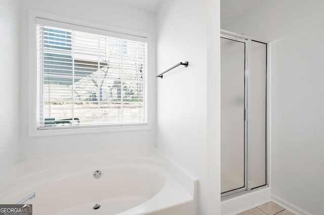 bathroom featuring tile patterned floors and an enclosed shower