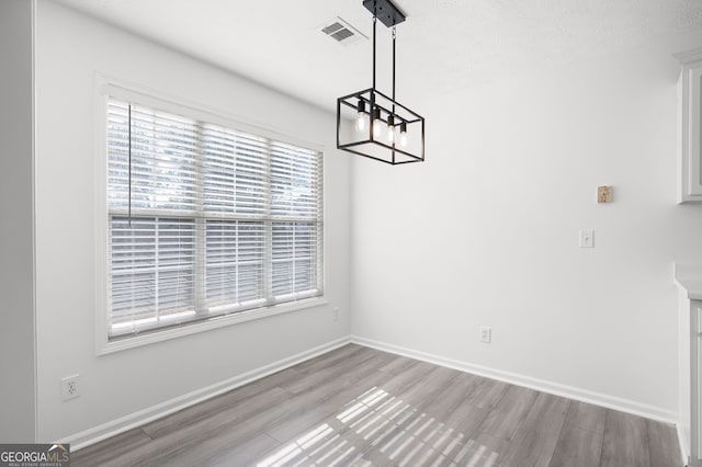 unfurnished dining area with light hardwood / wood-style floors