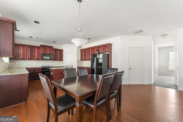 dining room with sink and dark hardwood / wood-style floors