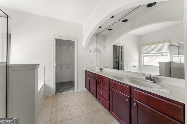 bathroom featuring tile patterned floors, vanity, and independent shower and bath