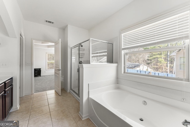 bathroom with tile patterned floors, vanity, and independent shower and bath