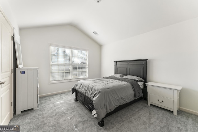 bedroom featuring carpet flooring and vaulted ceiling