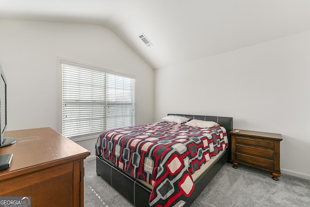 carpeted bedroom featuring vaulted ceiling