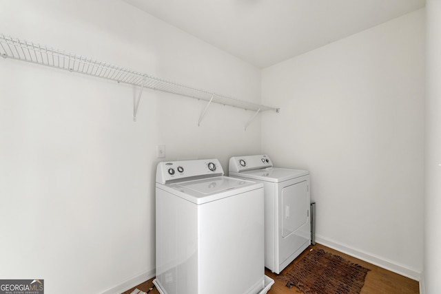 laundry room with washing machine and dryer and dark hardwood / wood-style floors