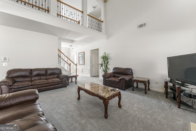 living room with light carpet and a high ceiling