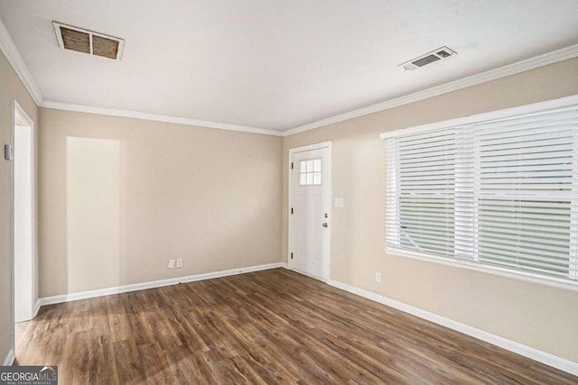 foyer with ornamental molding and dark wood-type flooring